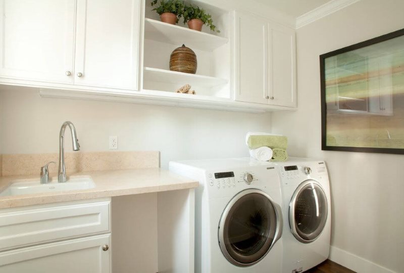 Place for a washing machine in the corner of the kitchen of a city apartment