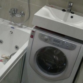 Sink above the washing machine in the bathroom without toilet