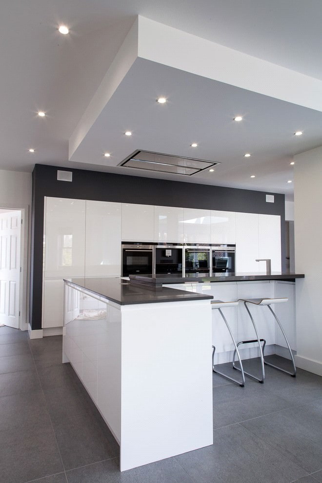 Black countertop on a kitchen island with white facades
