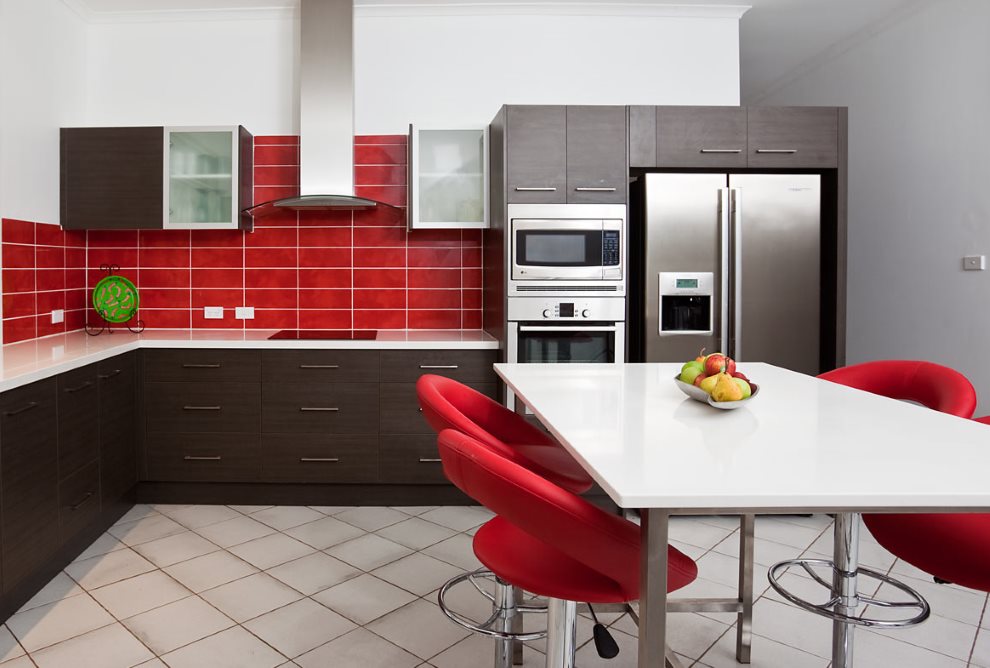 Red kitchen chairs near a white table