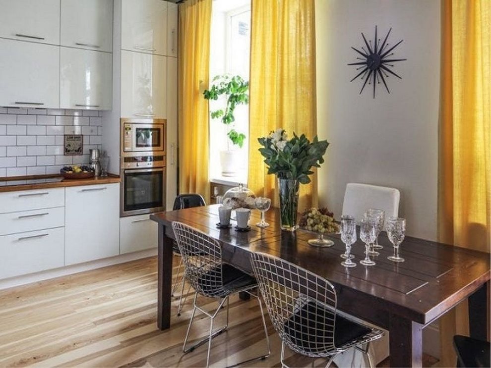 Yellow curtains in the kitchen with a white set