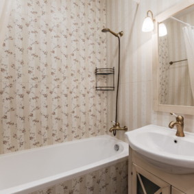 White plumbing in the bathroom with wallpaper