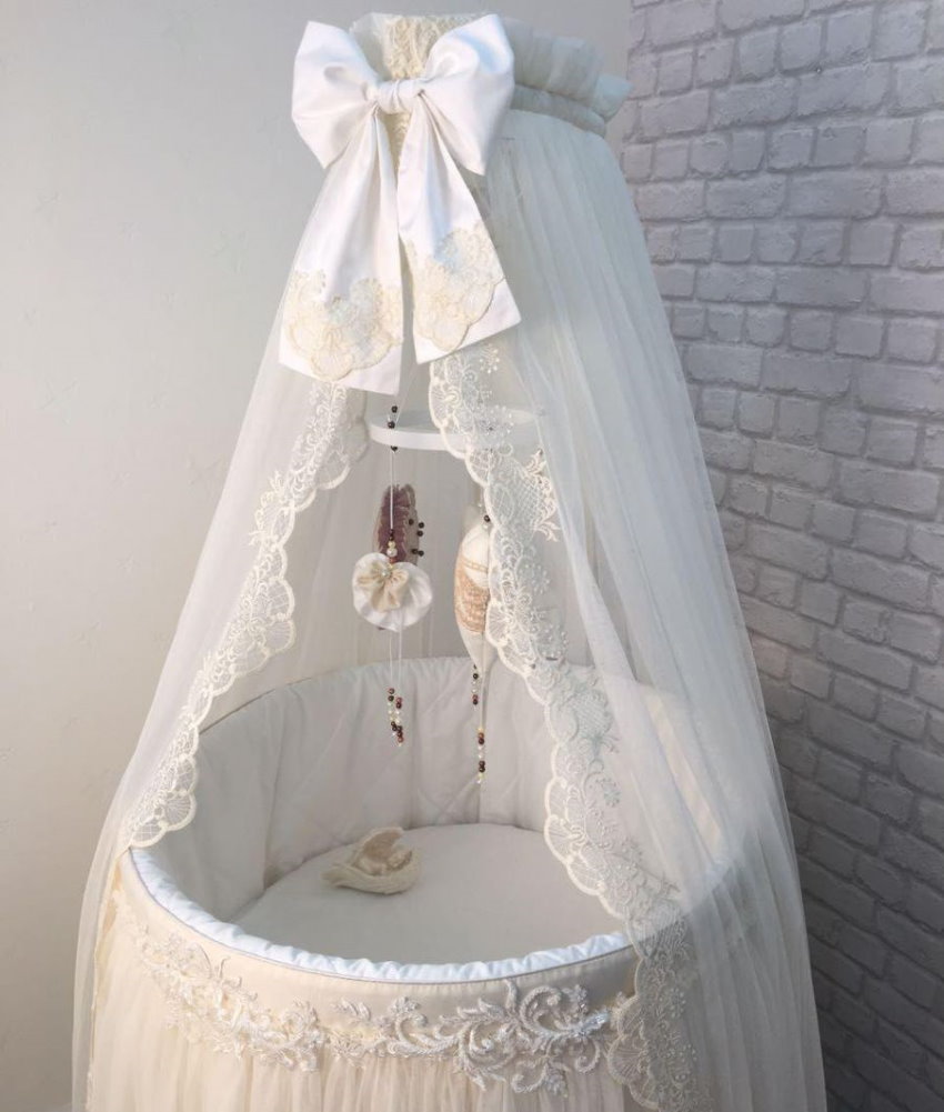 Openwork canopy on the crib for the baby