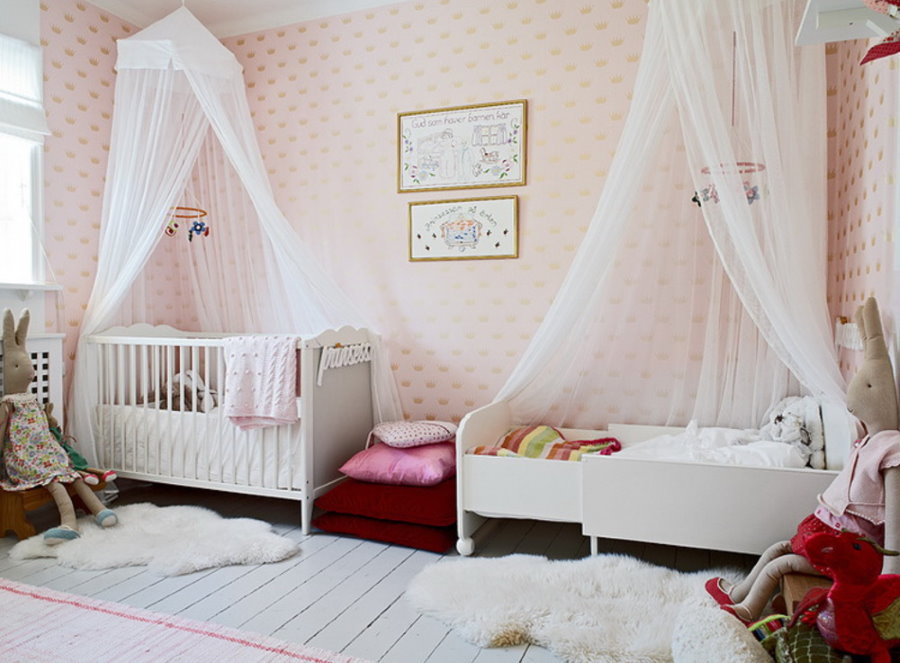 White canopies over beds in two girls bedroom