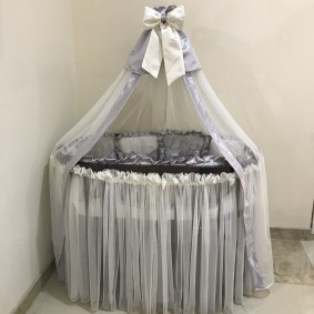 Satin ribbon bow on the top of the canopy