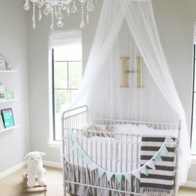 Glass chandelier in the room with a crib