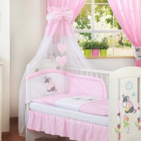 Crib for a little girl with a pink canopy