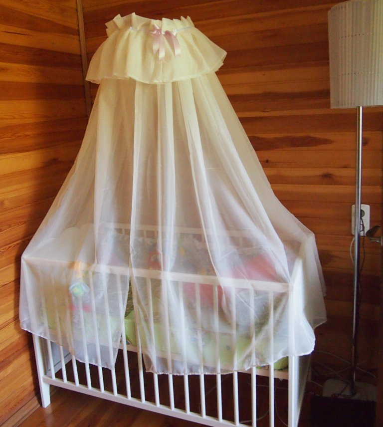 Synthetic fabric canopy over the crib