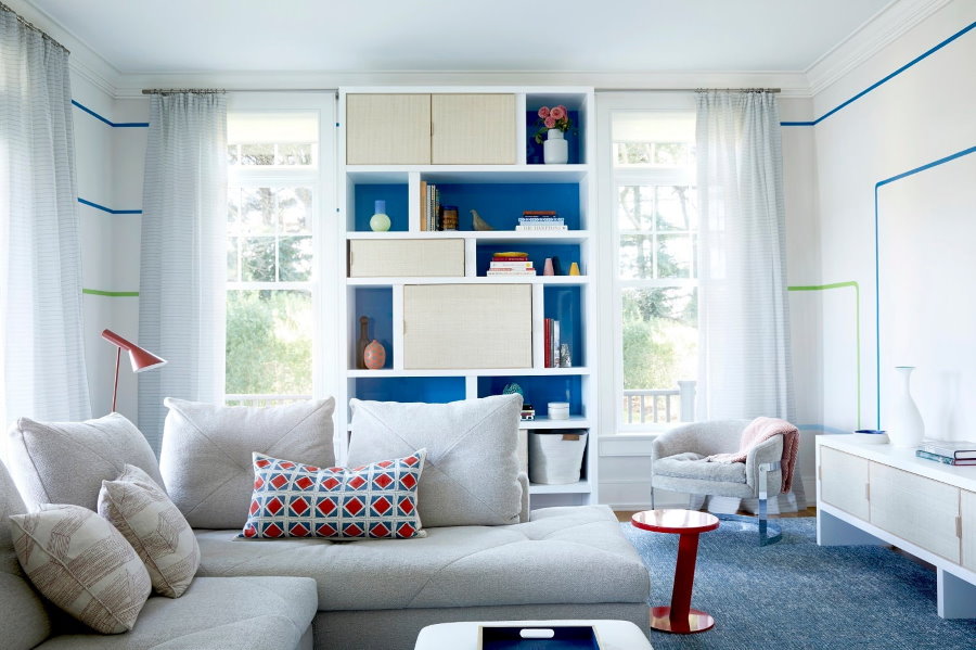White shelving between the windows in the living room