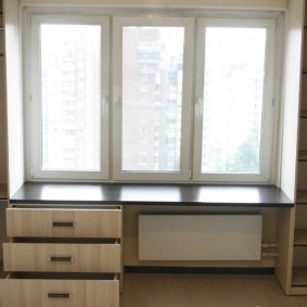 Drawers in cabinets near the window